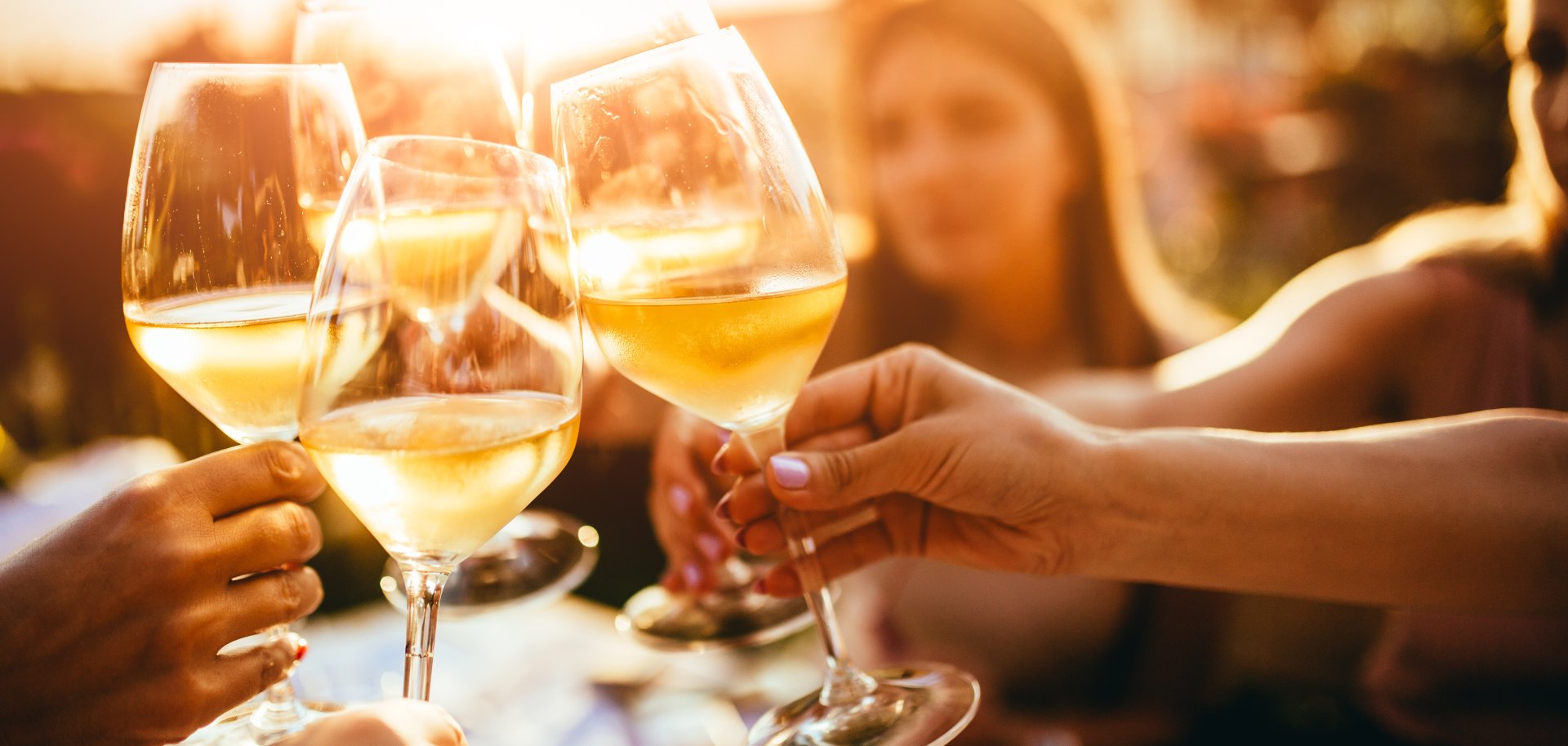 People clinking glasses with wine on the