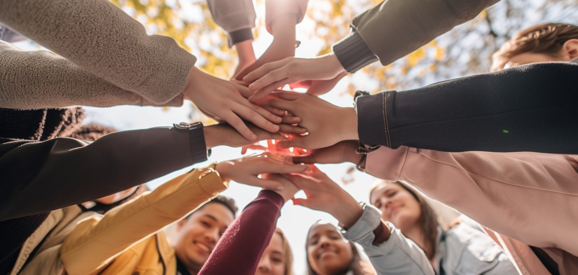 A gathering of young adults clasping their hands in unity - Diverse group of university students joining hands in a stack - The notion of human connection, societal bonds, communal Generative AI
