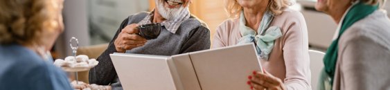 Happy mature friends talking about their memories while looking