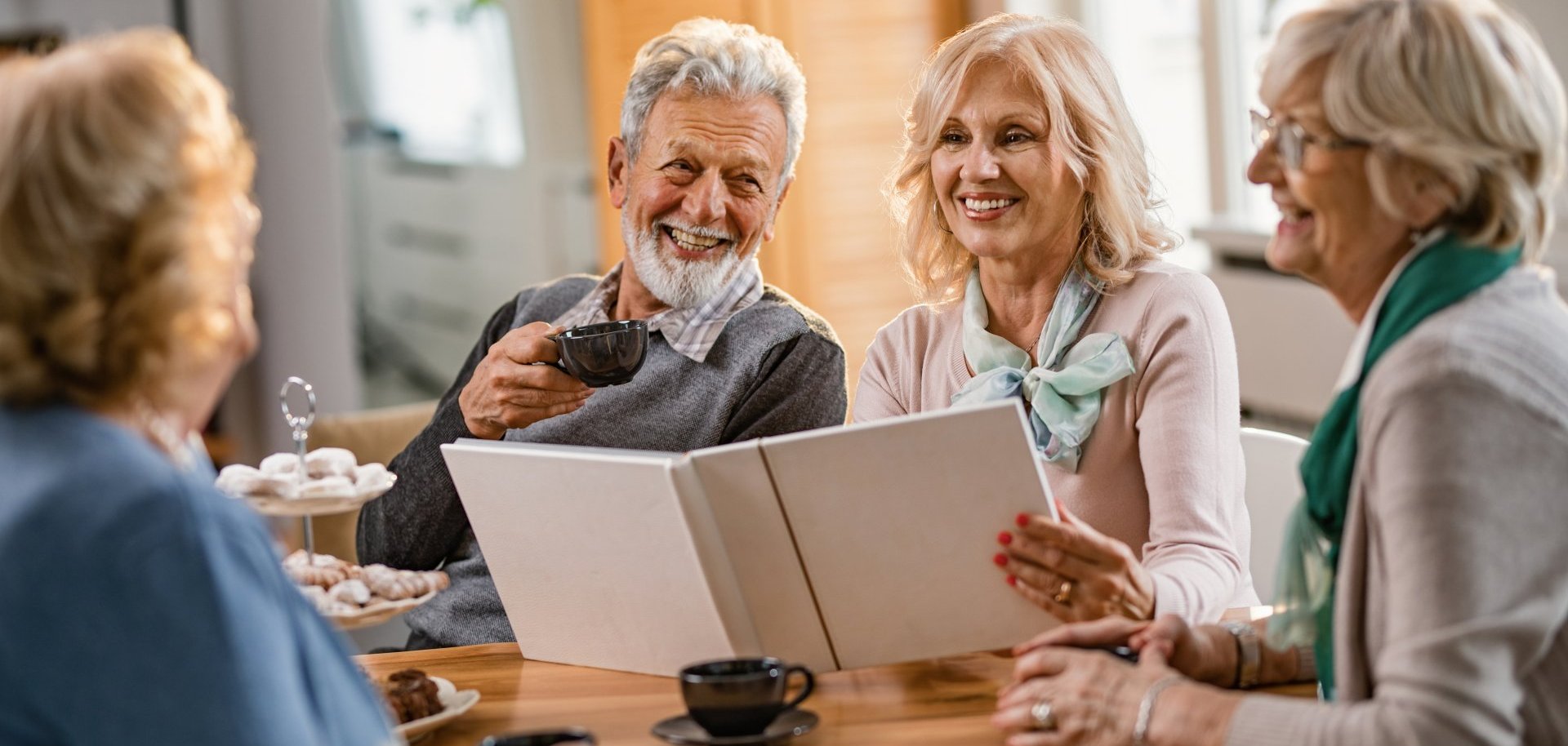 Happy mature friends talking about their memories while looking