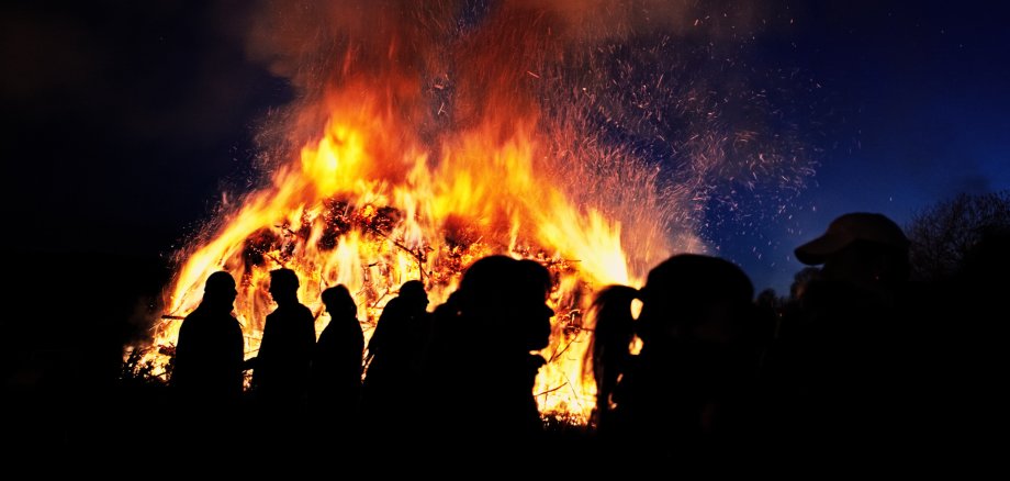 People standing in front of a traditional Easter fire in Germany