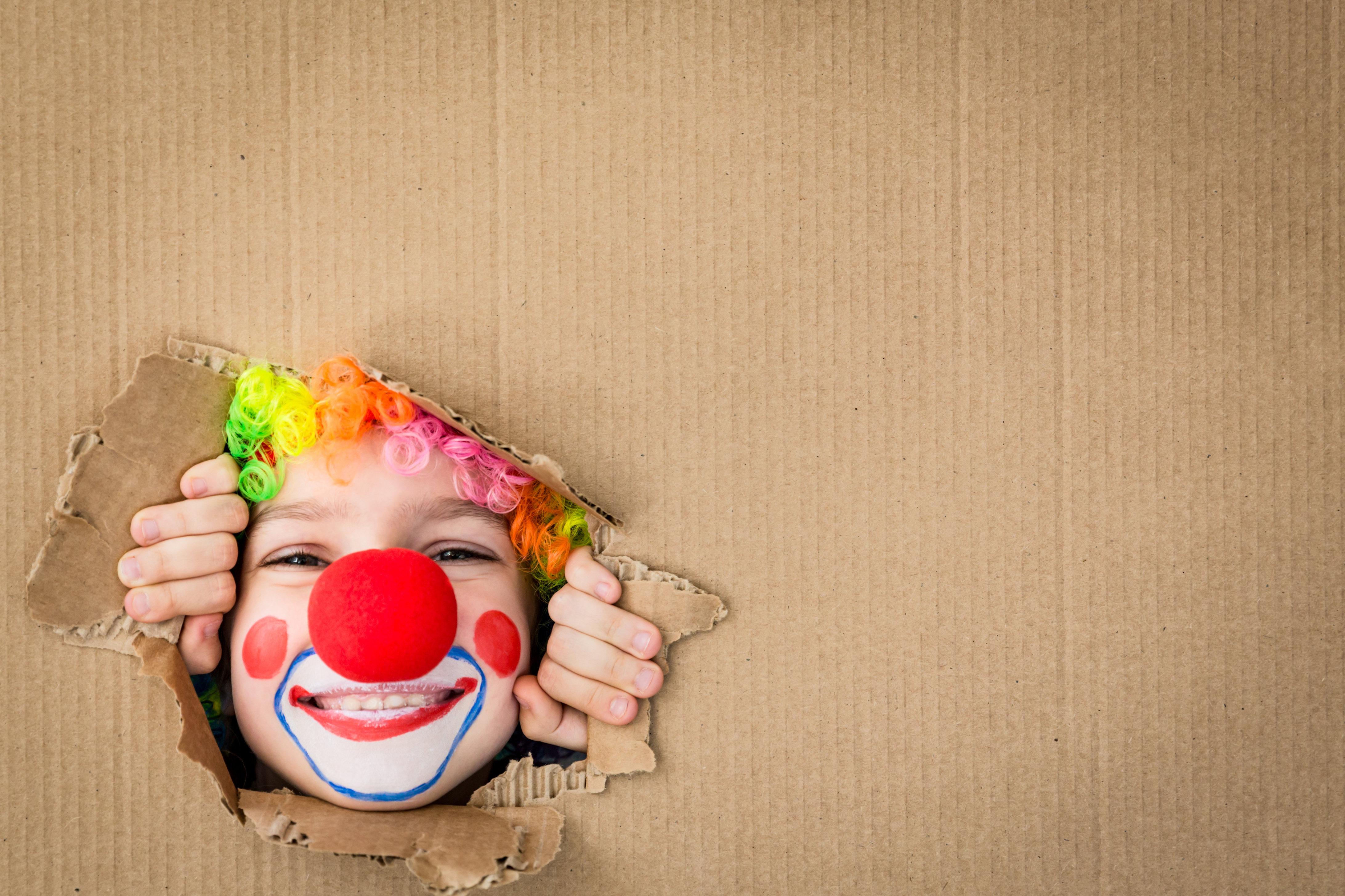 Funny kid clown playing indoor