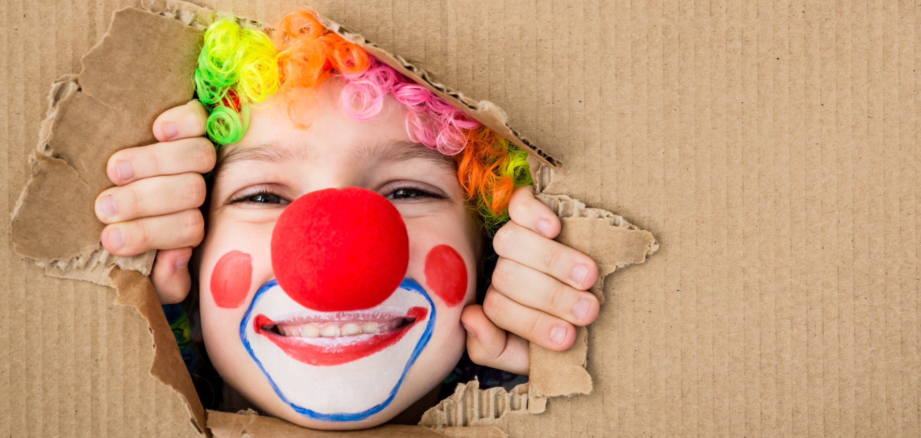Funny kid clown playing indoor